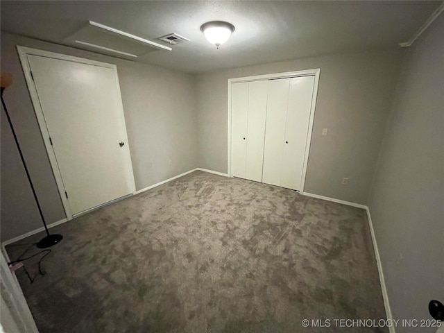 unfurnished bedroom featuring visible vents, baseboards, and carpet floors