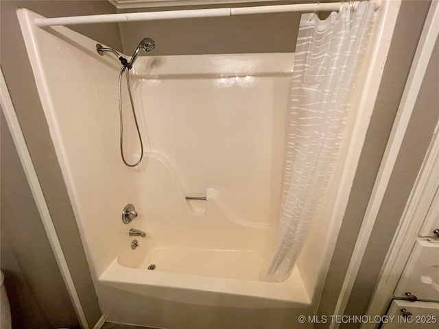 full bath featuring shower / tub combo with curtain