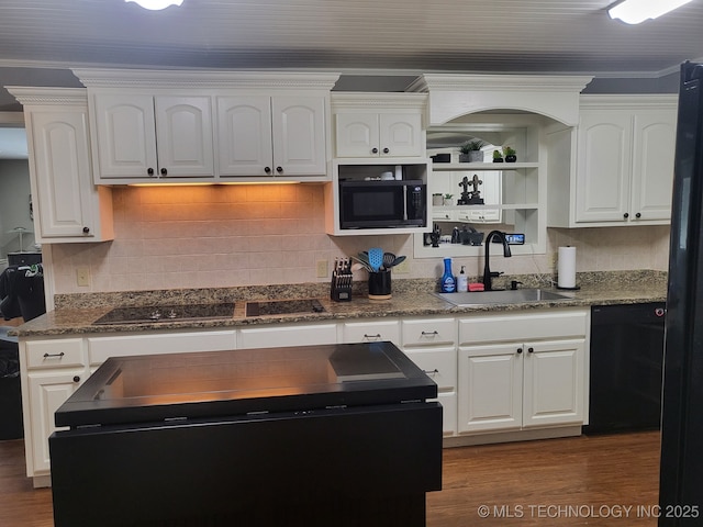 kitchen featuring black appliances, white cabinets, backsplash, and a sink