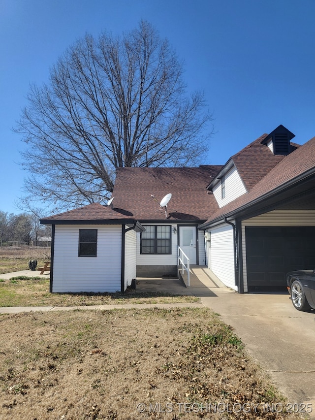 view of front facade with a garage, roof with shingles, driveway, and entry steps