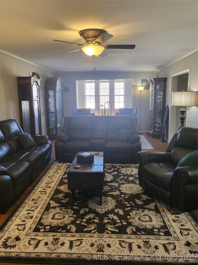 living room featuring ornamental molding and ceiling fan