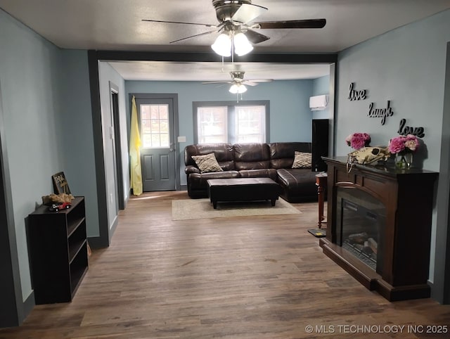 living room featuring wood finished floors and a ceiling fan