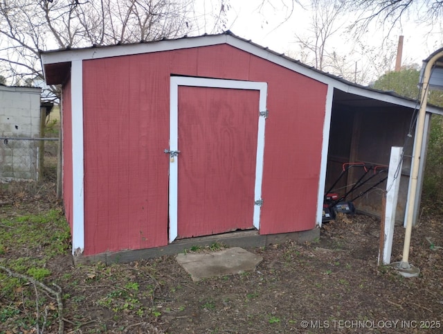 view of shed featuring fence