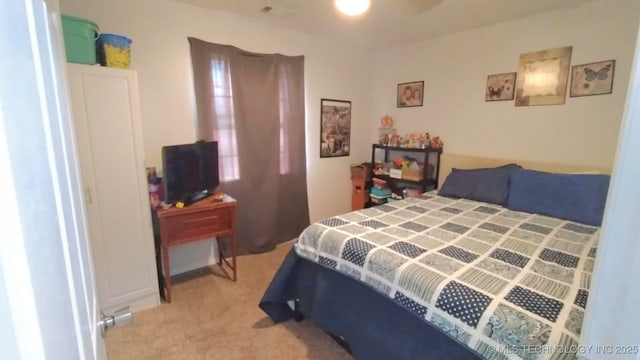 bedroom with visible vents and light colored carpet