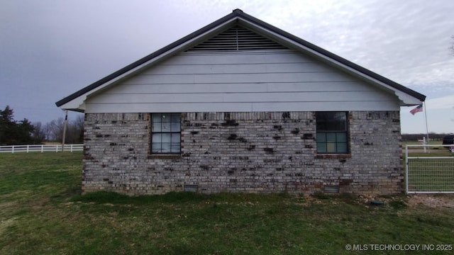 view of property exterior with crawl space, a lawn, and fence