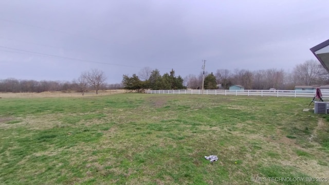 view of yard featuring a rural view and fence