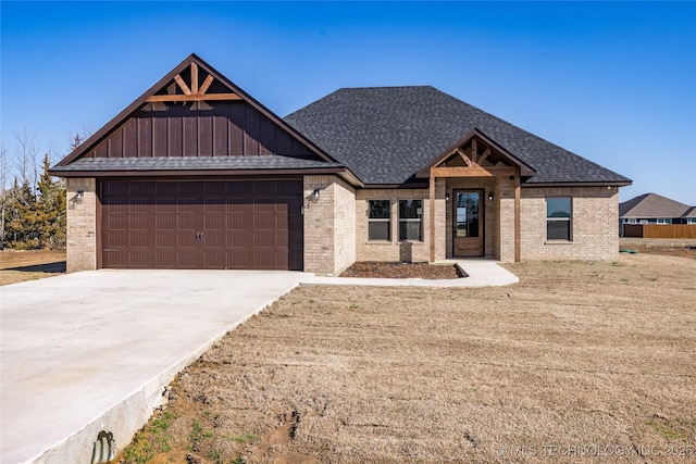 view of front of house with brick siding, driveway, and a shingled roof