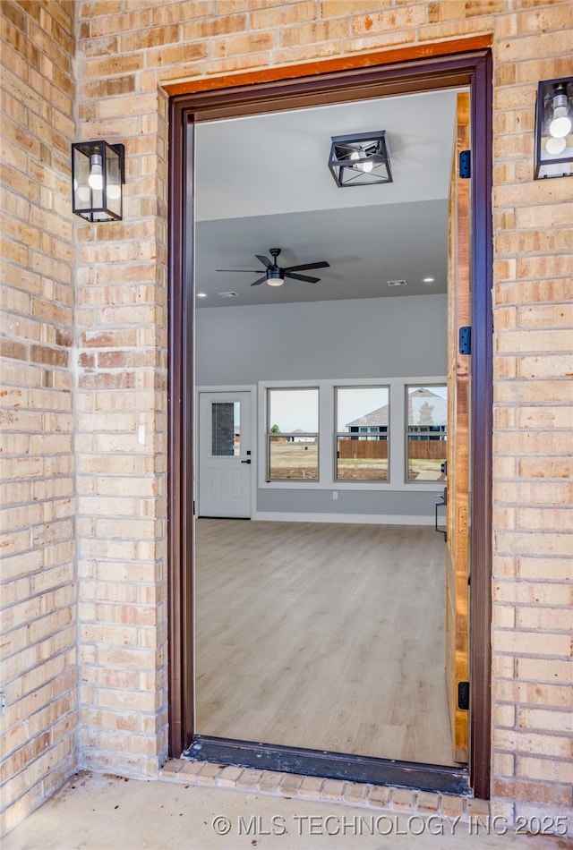 doorway to property with brick siding