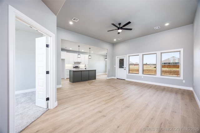 unfurnished living room featuring recessed lighting, a ceiling fan, visible vents, and light wood finished floors