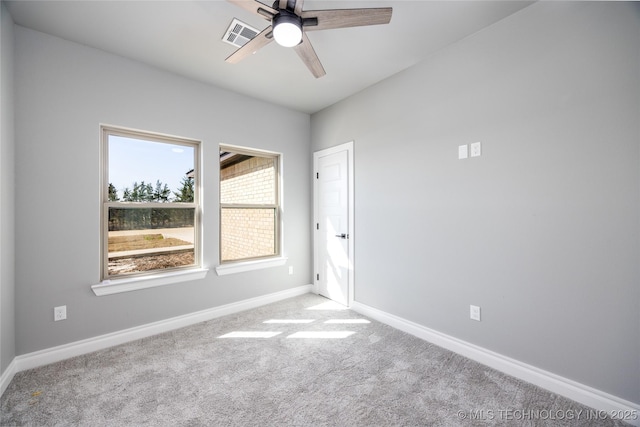 spare room featuring visible vents, baseboards, a ceiling fan, and carpet floors