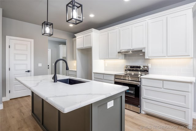 kitchen featuring backsplash, under cabinet range hood, stainless steel electric range, white cabinetry, and a sink