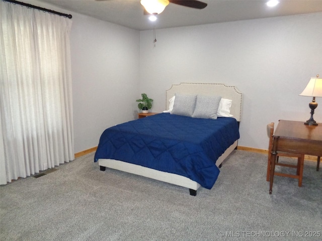 carpeted bedroom with baseboards and ceiling fan