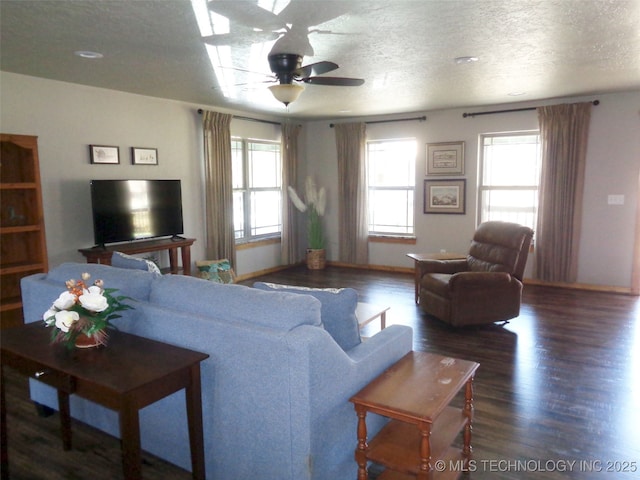 living area with plenty of natural light, a textured ceiling, wood finished floors, and a ceiling fan