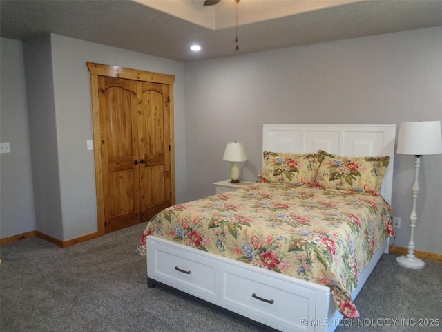 bedroom with baseboards, dark carpet, and ceiling fan