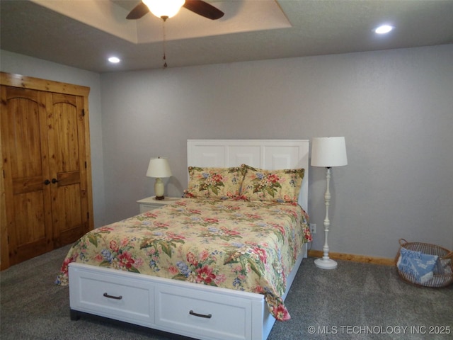 bedroom featuring a raised ceiling, a ceiling fan, recessed lighting, carpet flooring, and baseboards