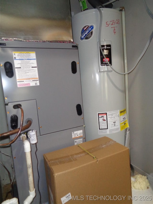 utility room featuring water heater