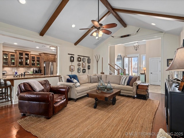 living room with beam ceiling, high vaulted ceiling, dark wood-style flooring, and ceiling fan with notable chandelier