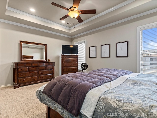 bedroom with a tray ceiling, crown molding, carpet, and visible vents