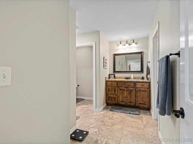 bathroom with vanity and baseboards