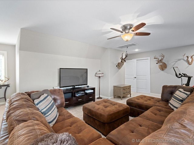 living area with visible vents, a ceiling fan, and baseboards