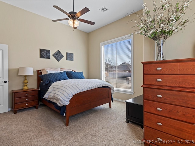 bedroom with light colored carpet, visible vents, and ceiling fan