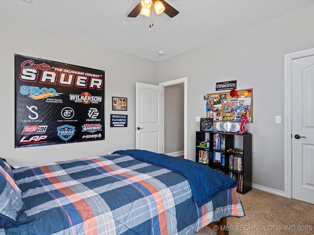 bedroom with ceiling fan, baseboards, and carpet