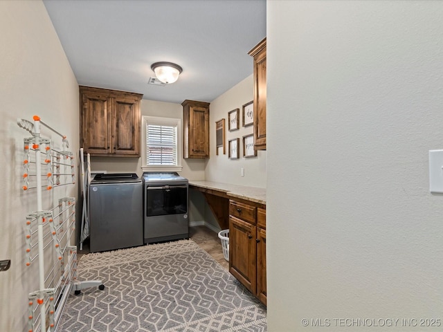 clothes washing area featuring cabinet space, washing machine and dryer, and visible vents