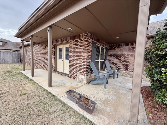 view of patio / terrace featuring french doors and fence