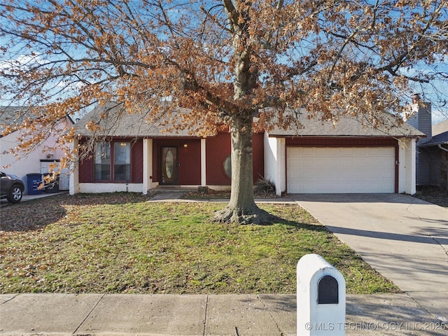 view of front facade with a garage, a front lawn, and driveway