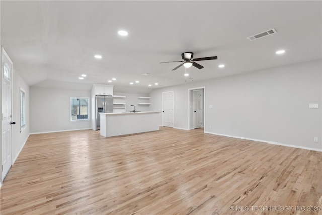 unfurnished living room featuring light wood-type flooring, visible vents, recessed lighting, and a ceiling fan