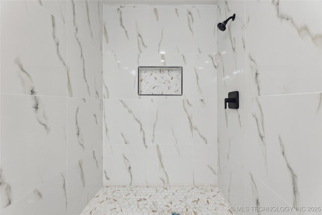 bathroom with a marble finish shower