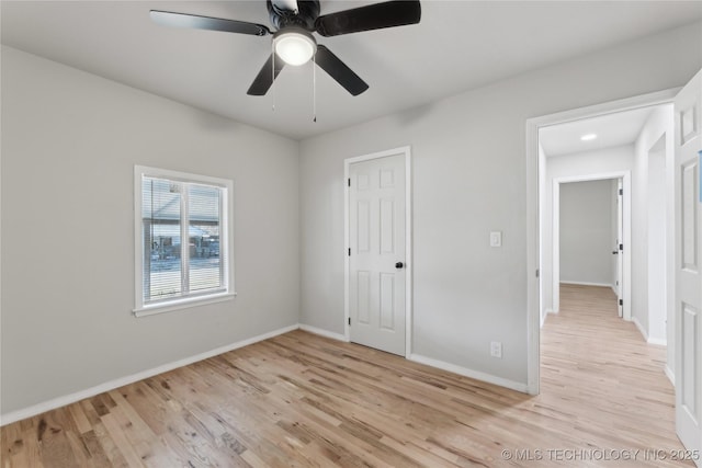 unfurnished bedroom featuring baseboards, ceiling fan, and light wood finished floors