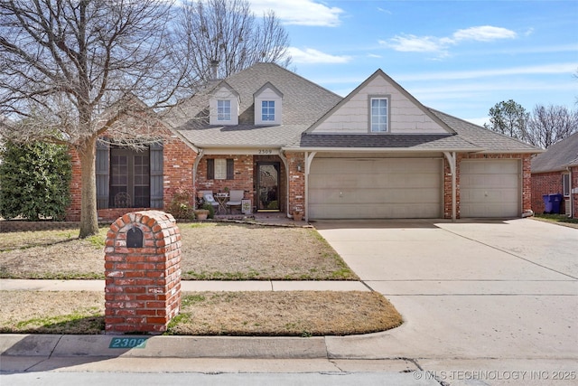 view of front of house featuring an attached garage, brick siding, driveway, and roof with shingles