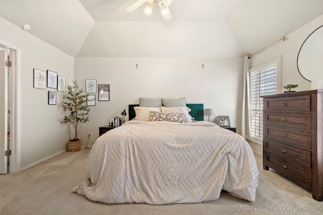 bedroom featuring light carpet, ceiling fan, baseboards, and lofted ceiling