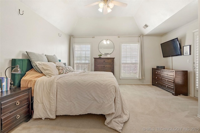 bedroom with visible vents, lofted ceiling, multiple windows, and light carpet