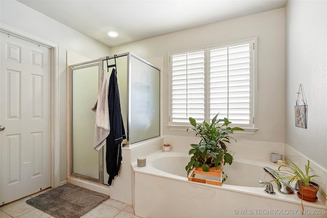 full bath with tile patterned flooring, a bath, and a stall shower