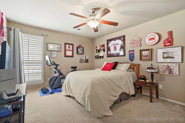 carpeted bedroom featuring baseboards and a ceiling fan