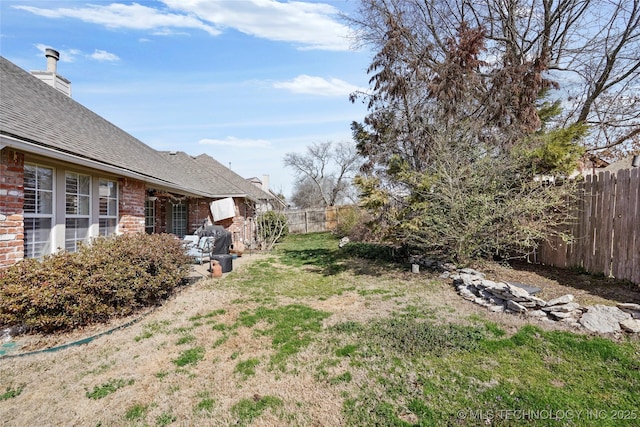 view of yard with a fenced backyard