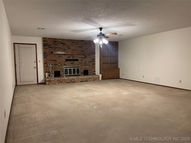 unfurnished living room with a textured ceiling, visible vents, carpet floors, and ceiling fan