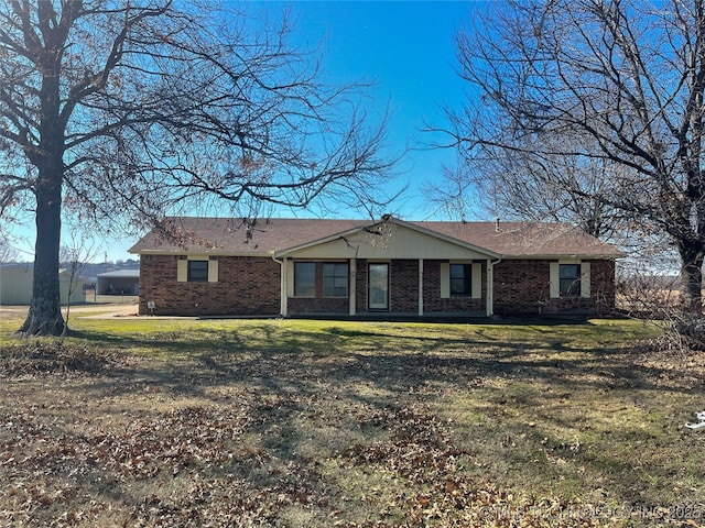 ranch-style home with brick siding and a front yard