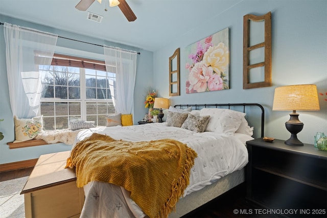 bedroom featuring visible vents, baseboards, and a ceiling fan