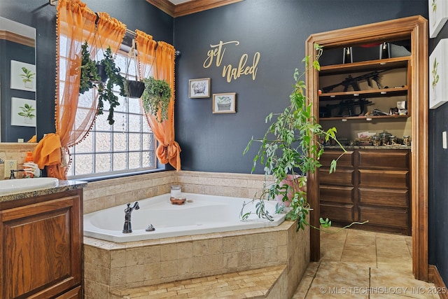 bathroom with vanity and a garden tub