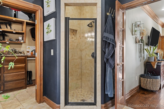 full bathroom with a stall shower and baseboards