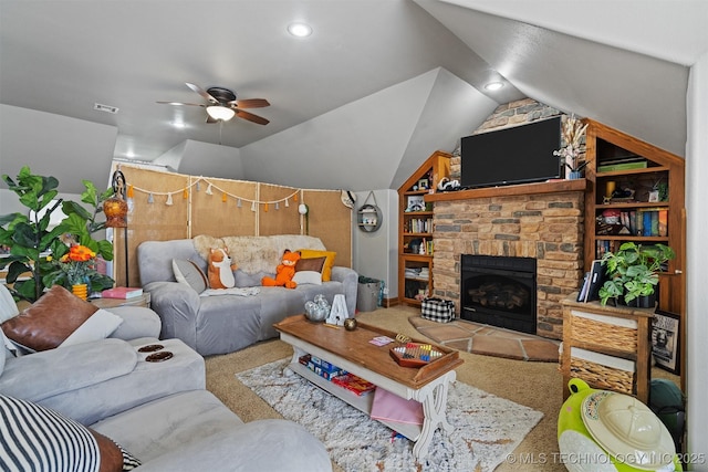 living area featuring visible vents, carpet floors, a stone fireplace, ceiling fan, and vaulted ceiling