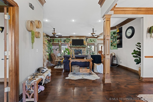 living area featuring ornamental molding, decorative columns, wood finished floors, and ceiling fan