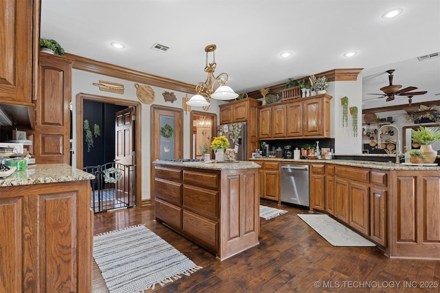 kitchen featuring visible vents, a kitchen island, appliances with stainless steel finishes, and ceiling fan with notable chandelier