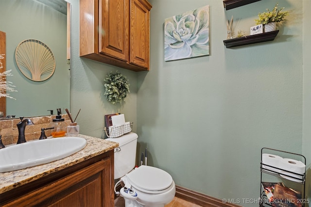 bathroom with toilet and vanity