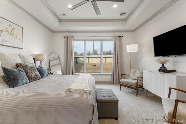 bedroom featuring ceiling fan, a raised ceiling, visible vents, and light carpet