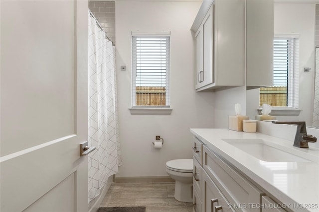 full bathroom with vanity, toilet, a shower with curtain, and baseboards