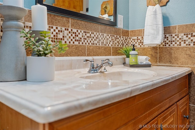 bathroom with vanity and tile walls